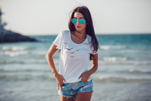 Load image into Gallery viewer, Flying High shirt on model at the beach